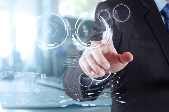 Double exposure of businessman shows modern technology as concept
